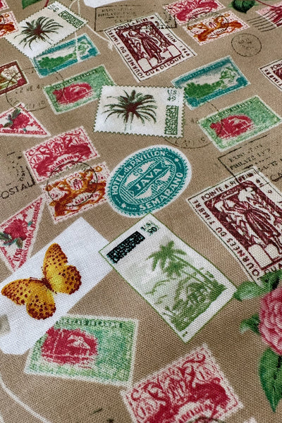 Paradise Travel Stamps in Tan Cotton Fabric by the yard